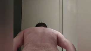 Chastity locked bear plays with his new tail toy