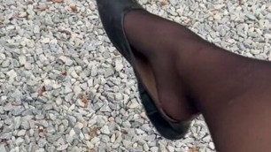 Shoe dangling outdoors in stockings